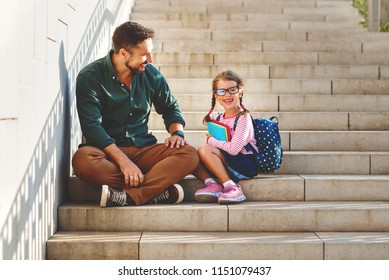 First Day At School. Father Leads A Little Child School Girl In First Grade
