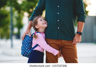 First Day At School. Father Leads A Little Child School Girl In First Grade
