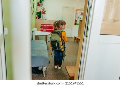 First Day At School Or Kindergarten. Back View Of Little Girl With Backpack Going Inside The School Door. Back To School Concept.