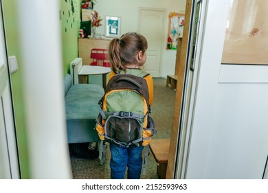 First Day At School Or Kindergarten. Back View Of Little Girl With Backpack Going Inside The School Door. Back To School Concept.