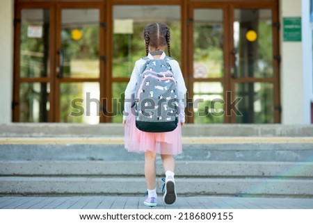 First day at school. A little school girl in first grade. Pupil of primary school. Back to school.