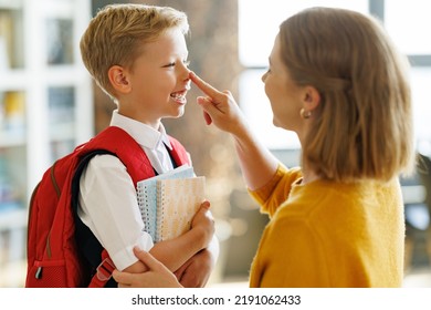 First Day At School. Mother Laughs And Touches The Nose Of A Her Cheerful Son During The  Preparing   For School Studies  At Home