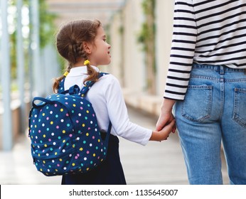 First Day At School. Mother Leads A Little Child School Girl In First Grade
