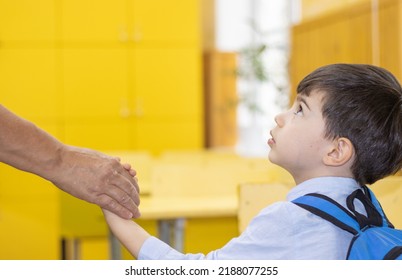 First Day At School Preschool Kid Holding Mother Grandmother Or Teacher Hand.woman Leads Child To His School Desk.yellow Furniture.scared Worried Boy Eyes Looking Up At Teacher.first Grade Back To