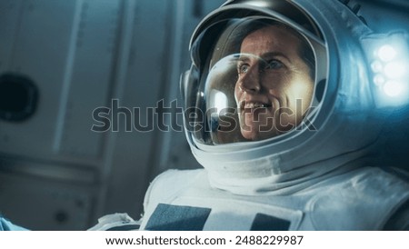 First Female Astronaut Landed on the Moon. Close Up of a Beautiful Female Astronaut Standing in Space, Looking at Planet Earth. Blue Planet Reflecting in Her Helmet. Space Travel Concept