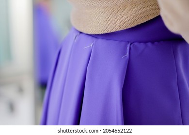 The first fitting of a skirt. Skirt in a fold, basting seams. Concept: atelier, cutting and sewing courses, custom tailoring, self-sewing. - Powered by Shutterstock