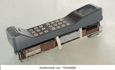 First Generation Style Of Cellular Mobile Phone With 1G Or 2G On Old Table With Vintage Tone Style. Big Vintage Mobile Phone.