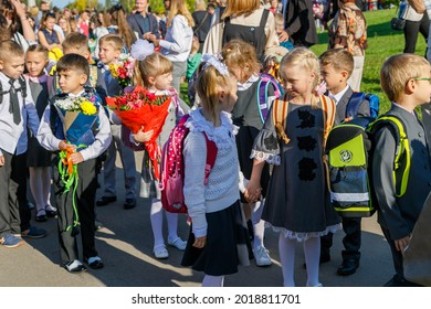 First Graders Celebrate The Start Of The School Year On September 1st. Children Go To First Grade With Flowers. School Education Concept. Moscow, Russia, September 2, 2019