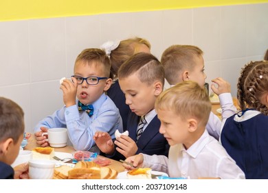 First Graders Eat In The School Cafeteria. School Lunch In The Cafeteria On September 1st. Moscow, Russia, September 1, 2021