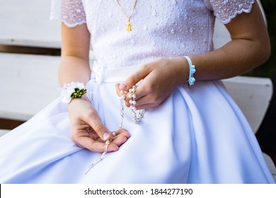 First Holy Communion - A Girl Holding A Rosary (close-up)