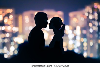 First kiss. Young romantic couple in the city at night.  - Powered by Shutterstock