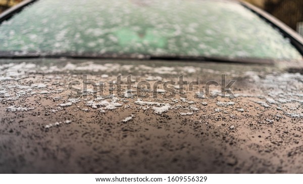 First layer of snow on cars in the morning. Winter\
season. Winter concept, cars on the road in Bucharest, Romania,\
2020