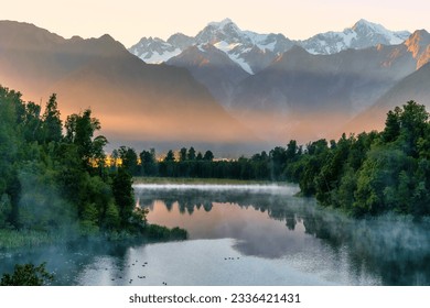 First light of the day at the beautiful Lake Matheson with some mist around the lakeshore