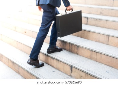 First Morning Of Work Businessman Hold Bag Walking Up The Stairs In A Rush Hour To Work. Hurry Time. Working Businessman