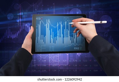 First person hand using tablet and checking financial report on cloud computing system - Shutterstock ID 1226092942