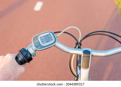 First Person Perspective On Control Panel On Handlebar Of Electric Bicycle While Driving On Bicycle Lane