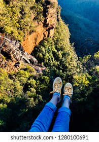 First Person Perspective Shot From A Hiker Sitting At The Edge Of A Cliff At Blue Mountains, Sydney. (Legs Hanging From The Cliff, Feet Selfie )
  - Travel Lifestyle Adventure Vacations Concept Int