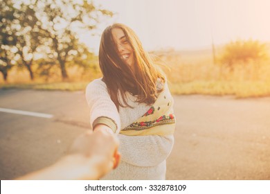 First Person Portrait Of A Smiling Girl Holding Hand On Sunset. Adorable Young Woman On Sunny Day