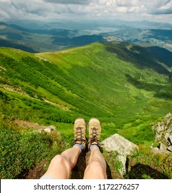 First Person View Of Active Male Hiker Enjoying View Of Beautiful Cloudy Sky In Mountains, Travel And Outdoor Adventure Concept. Carpathians, Ukraine. Mans Legs In Hiking Shoes In Focus