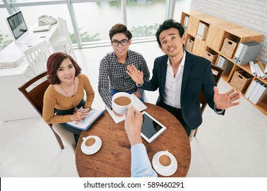 First Person View Of Businessman Cheering With Cup Of Coffee