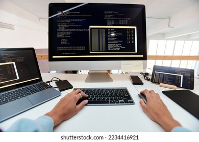 First person view of female software developer coding on computer