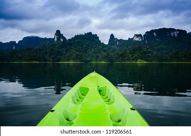 First Person View Of Green Kayak Against Blue Sky