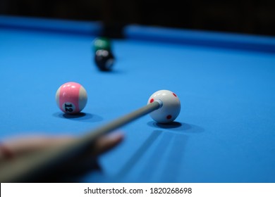 First Person View Of Holding Pool Cue Aiming At Cue Ball. Soft Focus