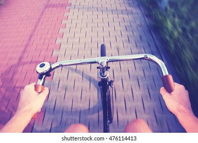 First Person View Of A Man Cycling On A City Bike Lane With Retro Filter