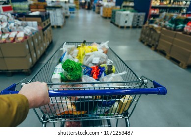first person view. man with trolley in grocery store. shopping concept