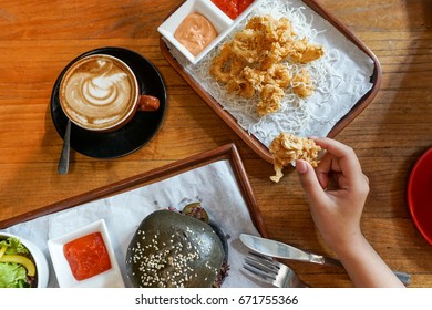 First Person View Though Calamari, Black Buns Burger And A Cup Of Coffee