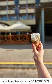 A First Person View, A Person Walking Along The Road With An Ice Cream In His Hands, Shallow Depth Of Field.