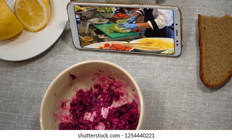 First Perspective View. Woman Has Breakfast In A Cafe. Point Of View. She Watches A Culinary Vlog Video On The Phone Screen.