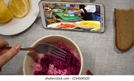 First Perspective View. Woman Has Breakfast In A Cafe. Point Of View. She Watches A Culinary Vlog Video On The Phone Screen.