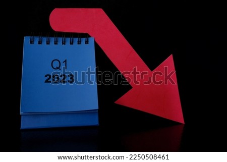 First quarter of 2023 negative performance financial report and fiscal concept. Downward arrow with decreasing coins and calendar in black background.