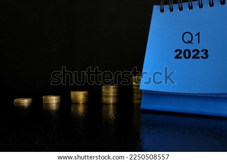 First quarter of 2023 positive growth performance financial report and fiscal concept. Upward arrow with increasing coins and calendar in black background.