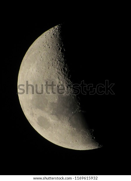 First Quarter Moon with relief highlighted by the\
light of the sun, observed the night in the southern hemisphere,\
sao paulo, brazil