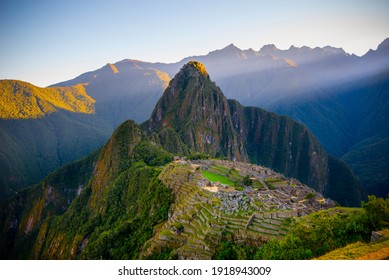 The first rays of the sun on Machu Picchu , the lost city of inca - Peru