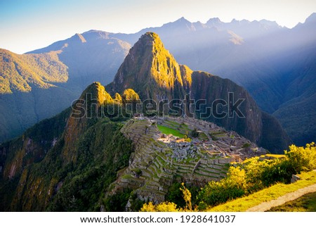 The first rays of the sun on Machu Picchu , the lost city of inca - Peru