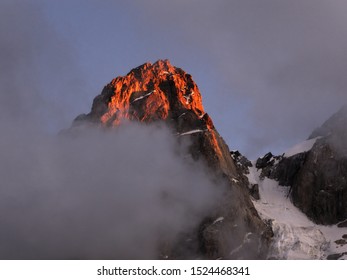 The first rays of the sun on a mountain peak