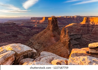 The first rays of warm sunlight hit the mesas off Marlboro Point above Shafer Canyon near Canyonlands National Park, Utah.
