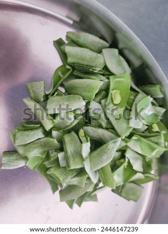 First, remove the beans from their pods, discarding any damaged or unsuitable ones. Next, gently pinch the broad bean at its seam and remove the outer skin. 
