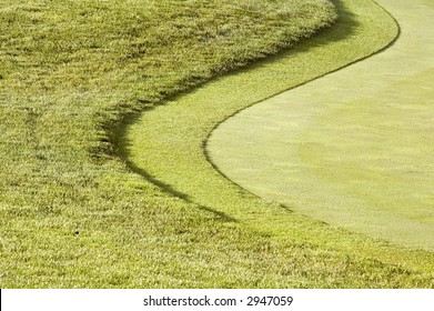 First And Second Cuts Of Rough Along Curved Fairway Of Golf Course