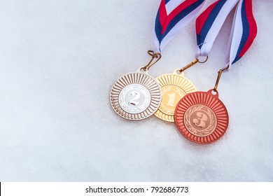 First, second, third place. Medal set, white winter background. Photo for winter olympic game.
