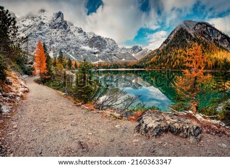 First snow covered of the shore of Braies Lake. Calm autumn scene of Dolomiti Alps, Naturpark Fanes-Sennes-Prags, Italy, Europe. Beauty of nature concept background.