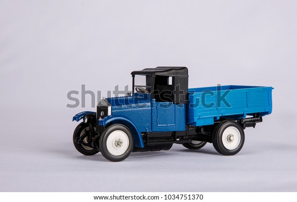 The first soviet car. Toy car, miniature copy of a\
retro car on a white background. Cargo delivery concept. Layout for\
illustration and design of postcards. Empty space for text.\
Isolate. Mockup