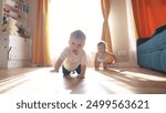 First steps. baby is crawling on the floor of an indoors bathroom. Cute kid infant family dream concept. group of baby are crawling around and playing. A group of baby are fun playing and crawling.