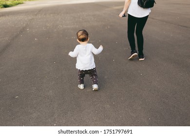 First Steps Of Little Girl. Mother And Her Toddler On Playground. Baby Girl Running Away Trying To Catch Her Mom. 