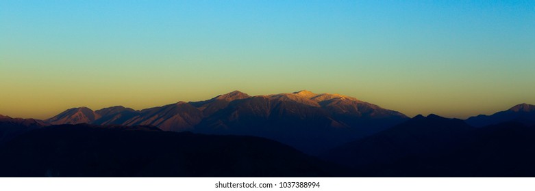 first sun rays fall on mountains