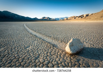 First sunlight hit the moving rock Rock on the racetrack in Death Valley, CA, USA - Powered by Shutterstock