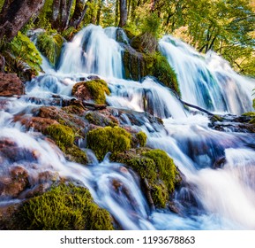 First Sunlight Lights Up The Pure Water Waterfall On Plitvice National Park. Colorful Spring Scene Of Green Forest With Blue Lake. Great Countryside View Of Croatia, Europe.